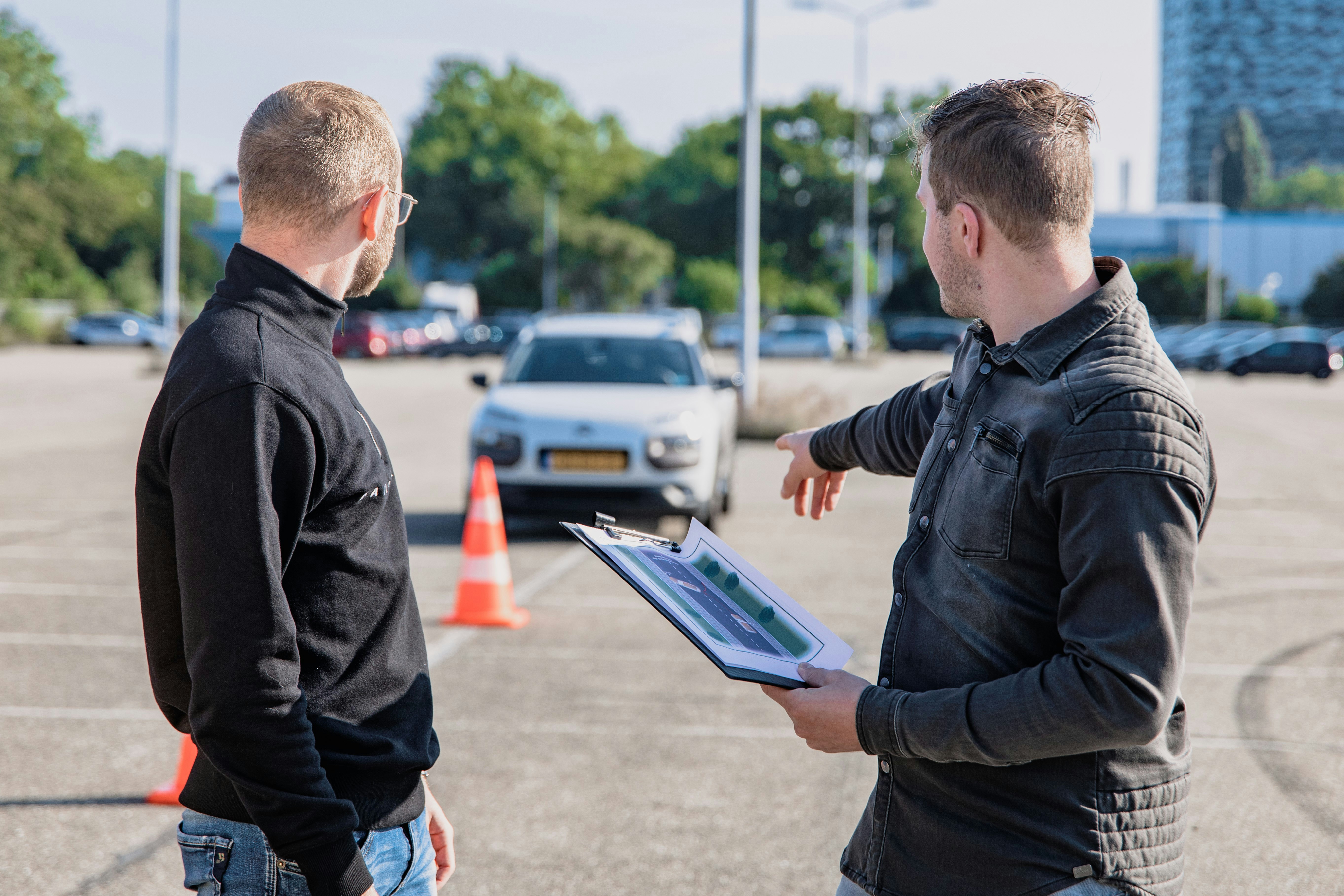 Student and instructor beside a car